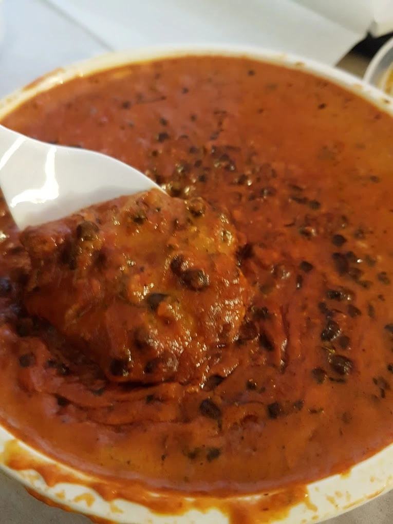 Coconut chicken curry in creamy sauce - mild Indian dish with coconut milk